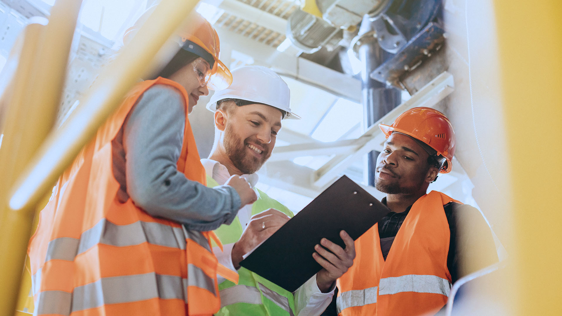 Three construction workers discussing plan